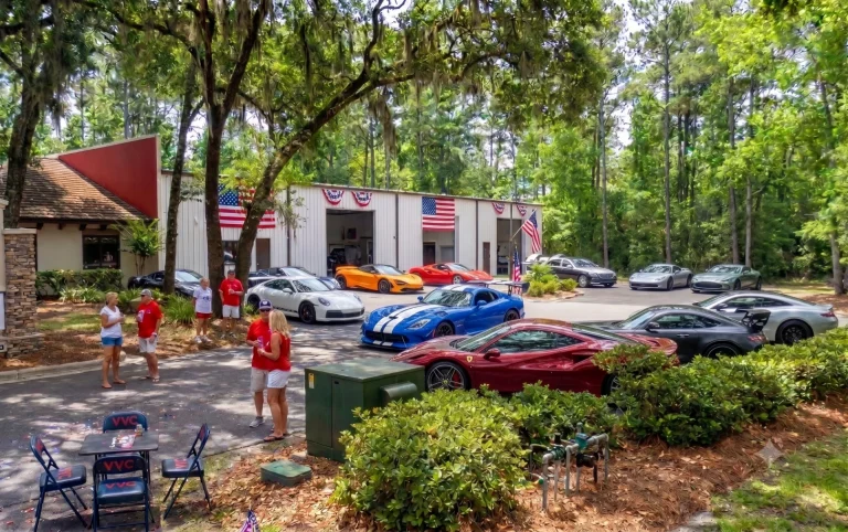 Exotic American muscle cars at Hilton Head Island marina with American flags and 4th of July fireworks sky